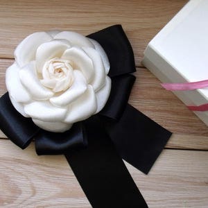 Ivory Satin Camellia Brooch: Handmade Fabric Flower Pin with Black Ribbon