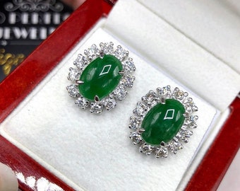 May include: A pair of jade and diamond earrings. The earrings feature oval-shaped jade stones surrounded by a halo of small diamonds. The earrings are set in white metal.