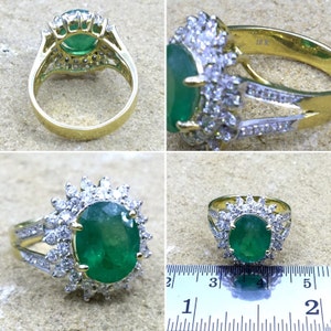May include: A gold ring with a large oval emerald gemstone surrounded by smaller diamonds. The ring is 16k gold and has a split shank.