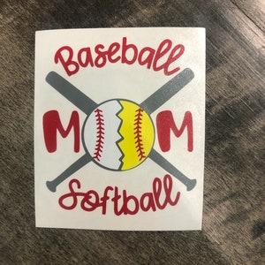 May include: White sticker with the words "Baseball Mom Softball" in red script. The word "MOM" is in large red block letters. A baseball and softball are in the center, with two gray bats crossed behind them.