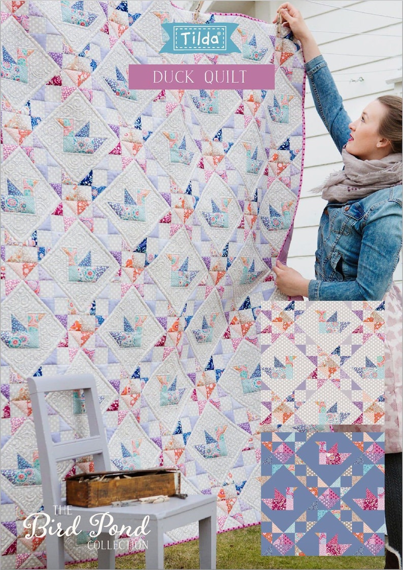 May include: A patchwork quilt with a duck design, made from various patterned fabrics. The quilt is labelled "Duck Quilt" and part of "The Bird Pond Collection". The quilt is displayed outdoors, with a pink border.