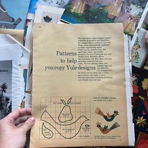 May include: A page from a vintage craft book with instructions and patterns for making felt Christmas decorations. The patterns include a pear, a bird, and a wing. The text reads "Patterns to help you copy Yule designs".