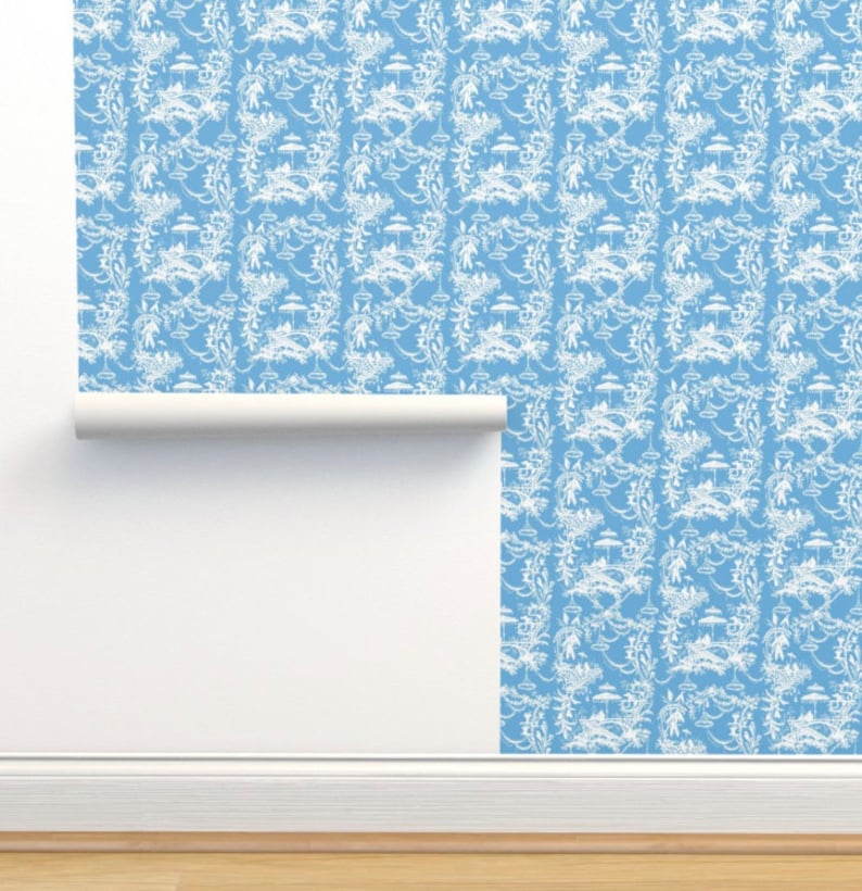 May include: A roll of blue wallpaper with a white floral pattern. The wallpaper has a repeating pattern of flowers, leaves, and vines.