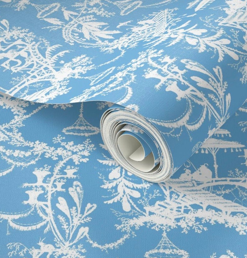 May include: A roll of blue wallpaper with a white repeating pattern of stylized trees and pagodas.