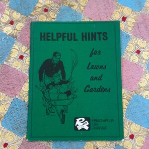May include: A green booklet titled "Helpful Hints for Lawns and Gardens" with a black illustration of a person pushing a wheelbarrow. The booklet also features the text "Prescription Soil Analysis".