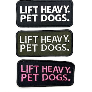 May include: Three black fabric patches with white, green, and pink embroidery. Each patch reads "LIFT HEAVY. PET DOGS."