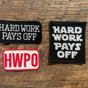 May include: Three embroidered patches with the text "Hard Work Pays Off" in white on black fabric, and "HWPO" in red on white fabric.