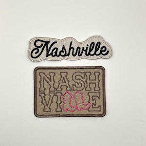 May include: Two embroidered patches featuring the word "Nashville" in different styles. The top patch is white with black lettering. The bottom patch is brown with black lettering and pink boot outlines.