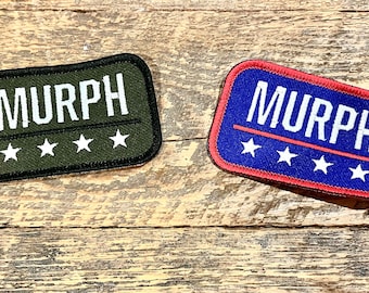 May include: Two fabric patches with the word "MURPH" in white lettering. The patch on the left is green with five white stars. The patch on the right is blue with a red border and five white stars.