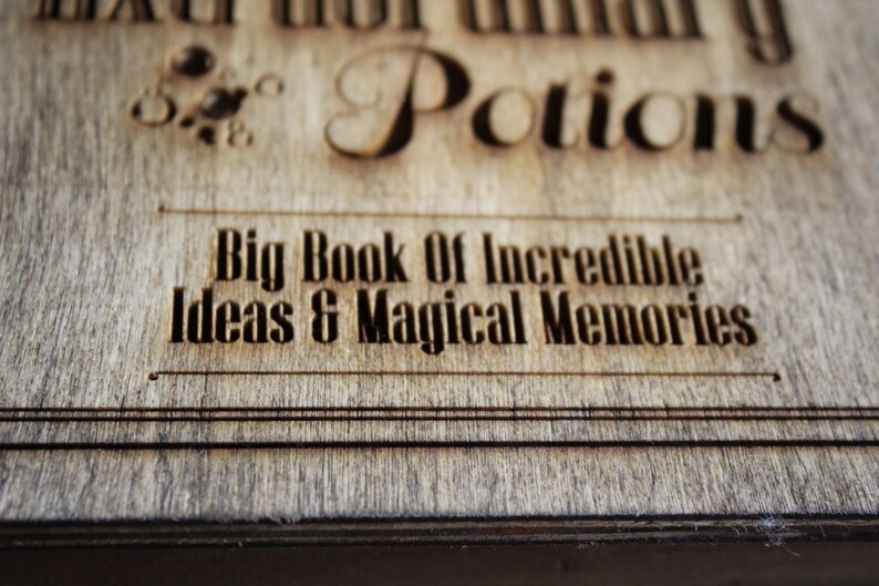 May include: A wooden box with the text "Big Book of Incredible Ideas & Magical Memories" engraved on the front. The box is made of wood with a natural finish.