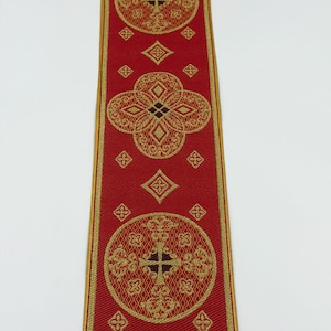 May include: Red ribbon with gold geometric patterns and the text "EMMA 253 No.4". The ribbon features repeating circular and diamond shapes with cross-like designs. The edges are trimmed with a gold border.