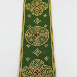 May include: Green ribbon with gold and red floral and geometric patterns. The ribbon has a gold border and features the text "EMMA 253 No.12". The design includes crosses and diamond shapes.