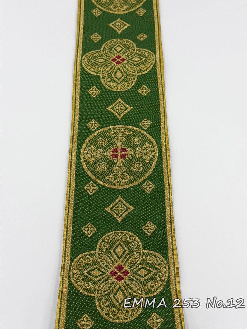 May include: Green ribbon with gold and red floral and geometric patterns. The ribbon has a gold border and features the text "EMMA 253 No.12". The design includes crosses and diamond shapes.