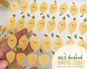 May include: A sheet of clear stickers featuring yellow lemons with smiling faces and small green leaves. The text on the sheet reads 100% deckend RANDLOSE STICKER FÜR ALLE GLATTEN OBERFLÄCHEN. The stickers are arranged in rows on a transparent backing.