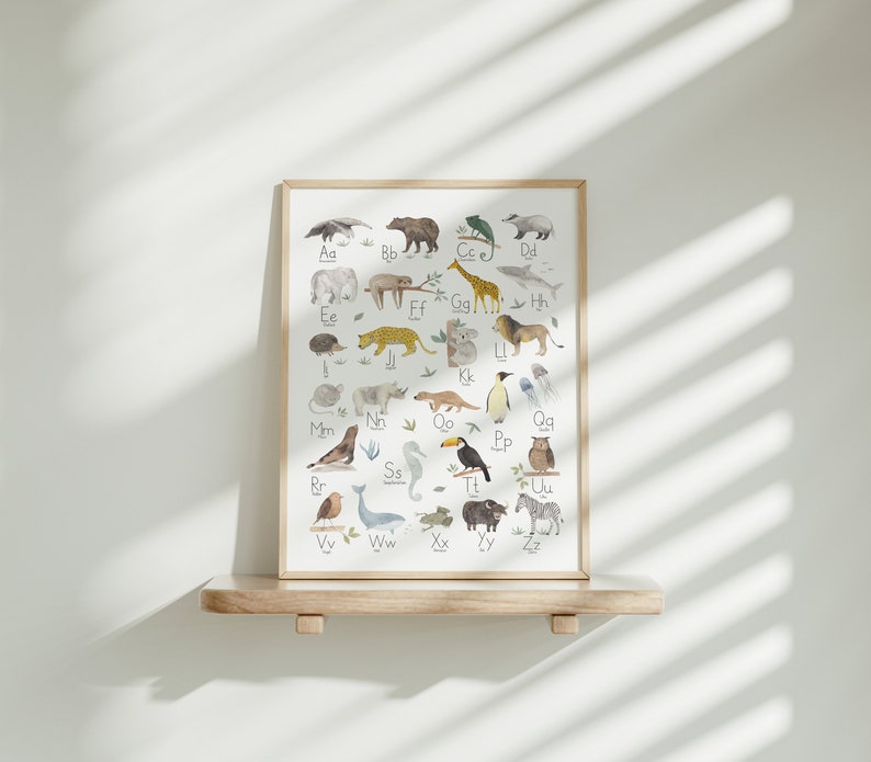 May include: A framed alphabet poster with illustrations of animals for each letter. The poster has a white background with black lettering and colorful animal illustrations.