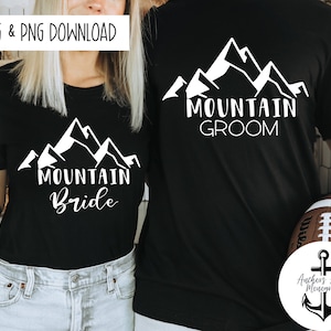 May include: Two black t-shirts with white mountain silhouettes and text. The shirt on the left says "Mountain Bride" and the shirt on the right says "Mountain Groom".