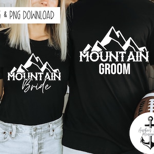 May include: A black t-shirt with a white mountain range graphic and the text "Mountain Bride" on the front. A black t-shirt with a white mountain range graphic and the text "Mountain Groom" on the front.
