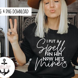 May include: A black sweatshirt with white text that reads "I put a spell on him now he's mine" with a diamond ring graphic.