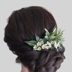 Floral hair comb with white wax flowers and green leaves