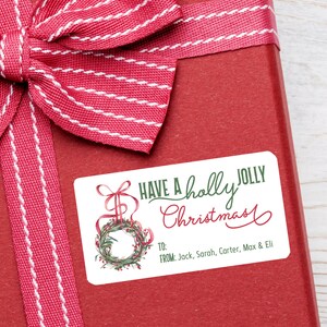 May include: A red gift box with a white and red striped ribbon bow. A rectangular sticker on the box reads "Have a holly jolly Christmas" with a wreath illustration and the names Jack, Sarah, Carter, Max & Eli.