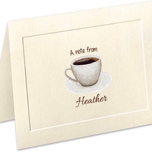 May include: A cream-colored card with a brown border. The card has a drawing of a white coffee cup with brown coffee inside. The text "A note from Heather" is written in brown below the cup.