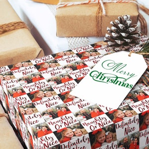 May include: A Christmas gift wrapped in white paper with a repeating pattern of photos and the text "Naughty or Nice" and "Definitely Nice". The gift is tied with twine and a white gift tag with green text that reads "Merry Christmas".