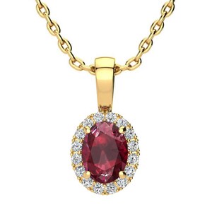 May include: A gold chain necklace with a pendant featuring a red oval gemstone surrounded by a halo of smaller white gemstones.