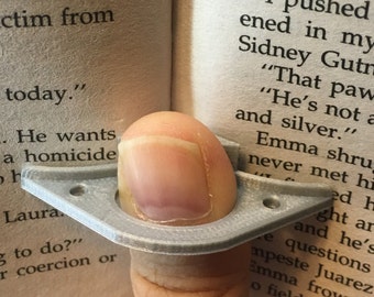 Thumb thing, reading ring, page holder, reading holder, reading ring, one handed reading, open book, thumb ring, hold book easy