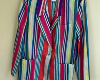 May include: A colorful striped blazer in shades of pink, purple, teal, yellow, and gray. The blazer has a classic design with a notched collar, two front pockets, and a single button closure. The garment is hanging on a clear hanger.