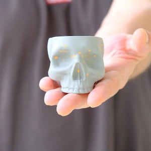 Handmade Gothic Skull Espresso Cup: Matte Gray Ceramic with Orange Splash