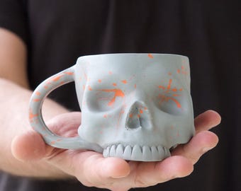 Handmade Gothic Skull Mug: Matte Charcoal Ceramic Coffee Cup with Orange Splatter