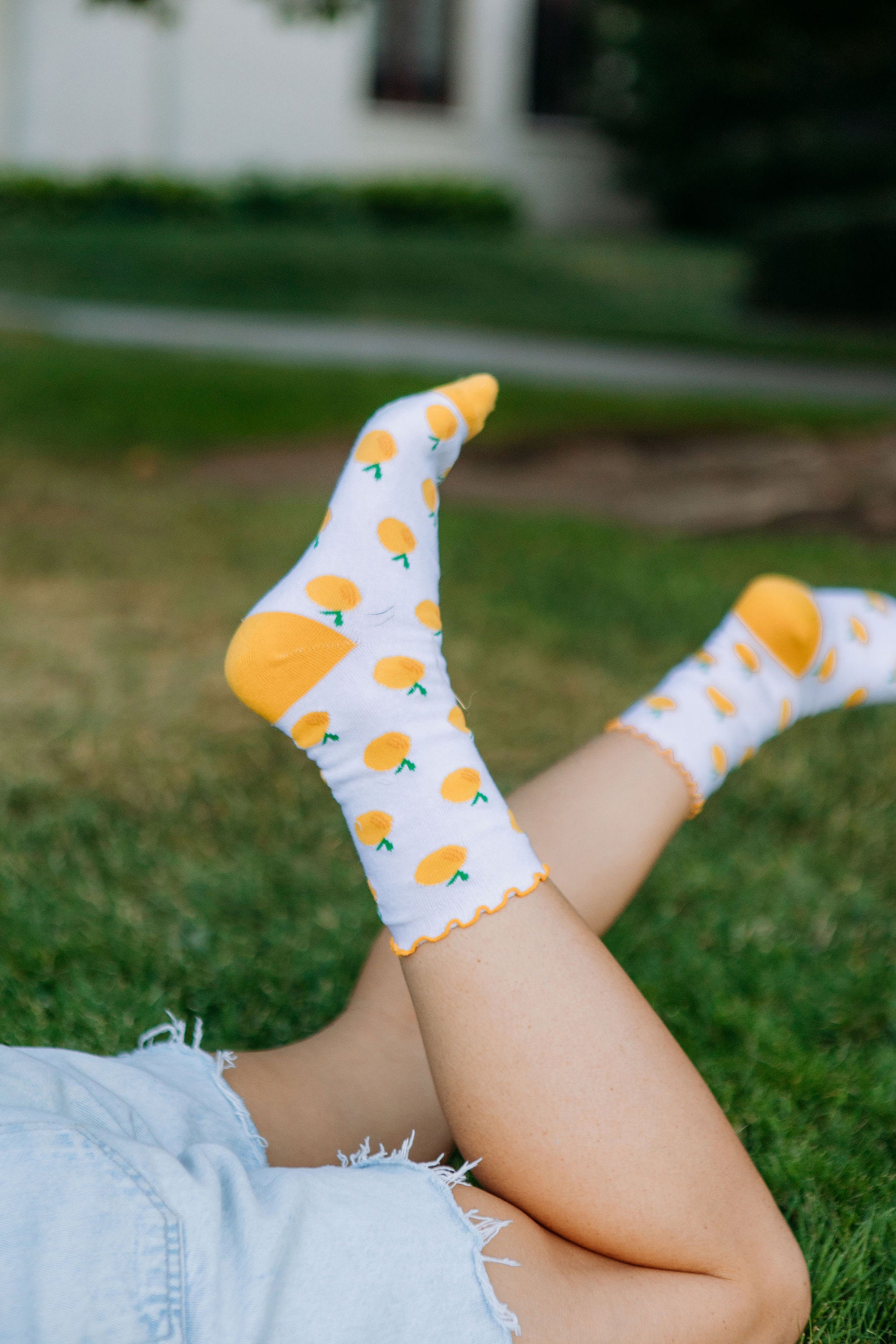 Cropped back view of beautiful woman's legs in orange socks with