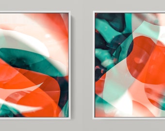 May include: Two abstract art prints with a white background and overlapping shapes in shades of orange, teal, and white.
