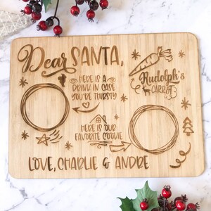 May include: A wooden sign with the text "Dear Santa" and spaces for a drink, cookie, and a carrot for Rudolph. The sign also includes the text "Love, Charlie & Andre".