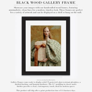 Sidonie portrait displayed in a black wood gallery frame with wide white matting, showing her sculptural green dress and folio of handwritten pages.