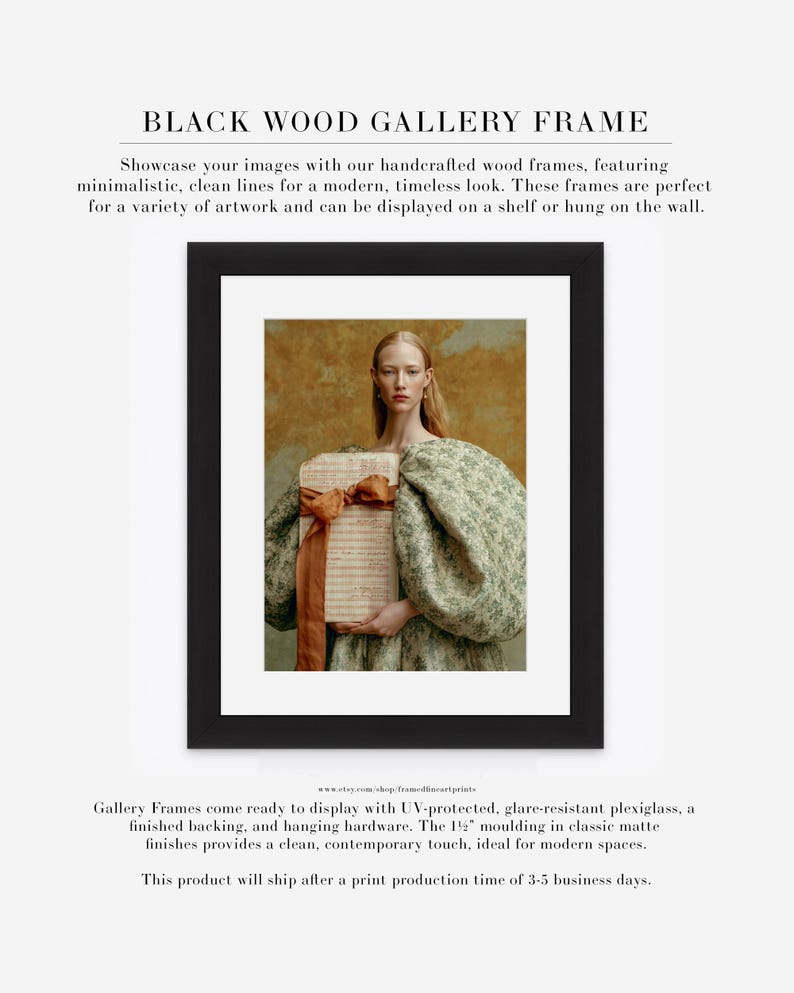 Sidonie portrait displayed in a black wood gallery frame with wide white matting, showing her sculptural green dress and folio of handwritten pages.