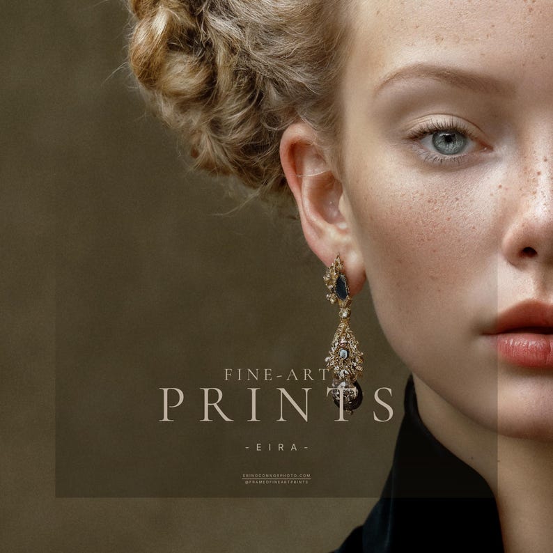 Close detail of Eira fine art print showing blue eye, freckles, braided hair, jeweled earring, and black collar