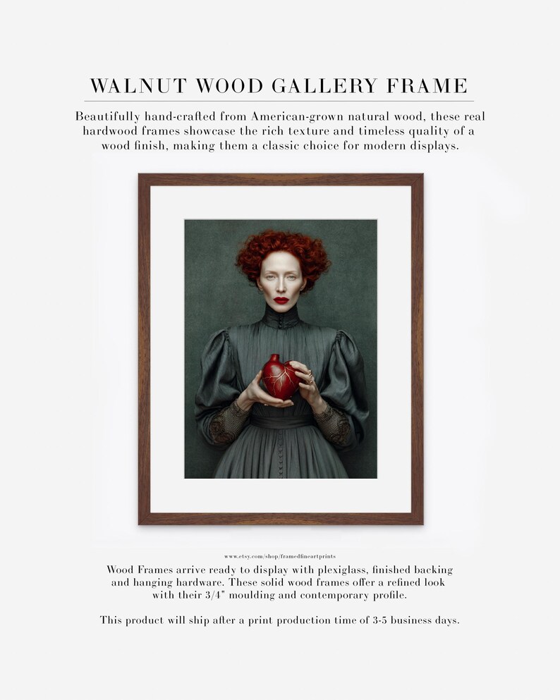 Framed artwork of Cinder in a walnut wood frame with white matte, showcasing a Victorian-style portrait of a woman in a dark dress holding a deep red heart-shaped vessel.
