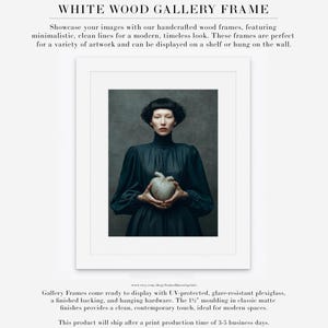 Portrait of Sable framed in a white wood gallery frame with matte, featuring soft light and emotional depth with her ceramic heart centerpiece.
