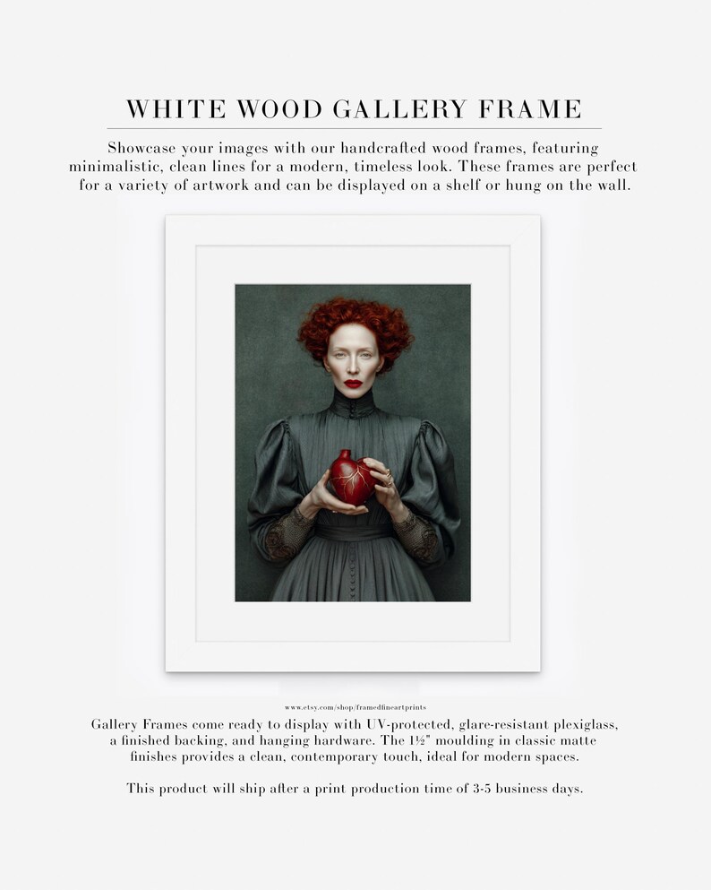 Fine art print of Cinder framed in a white wood frame with matte, highlighting a red-haired woman in vintage attire holding a sculpted heart on a moody green background.