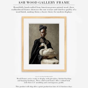 Vaelora woman-with-swan fine art portrait displayed in a natural ash wood gallery frame with a wide white mat.