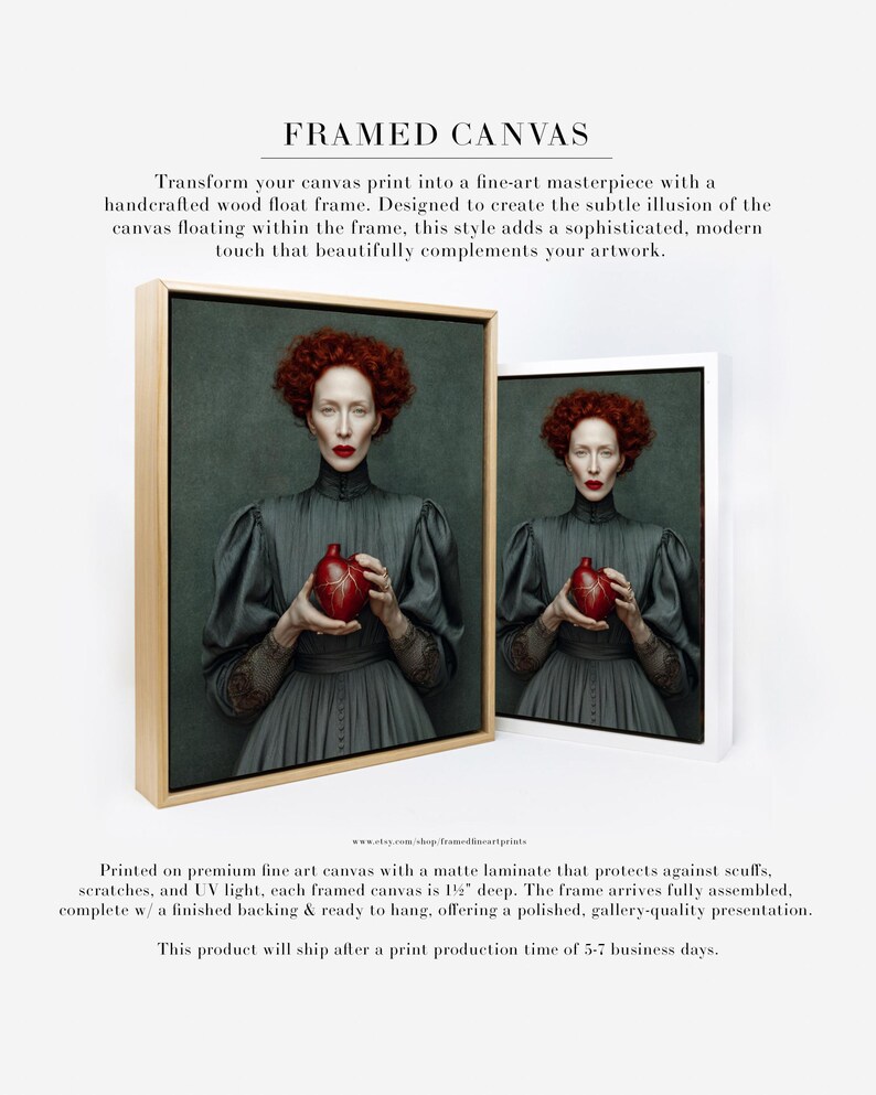 Framed portrait of Cinder printed on canvas and displayed in a modern natural wood float frame, featuring a red-haired woman holding a sculpted heart vessel on a moody green background.