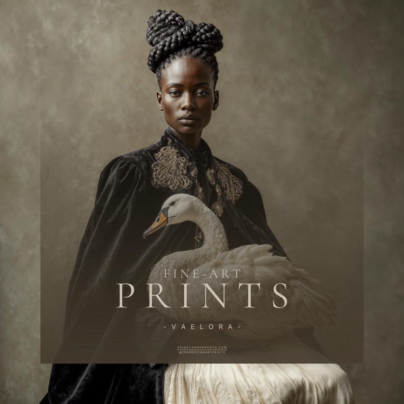Vaelora fine art portrait of a Black woman in a black embroidered velvet cape holding a white swan against a soft taupe background.