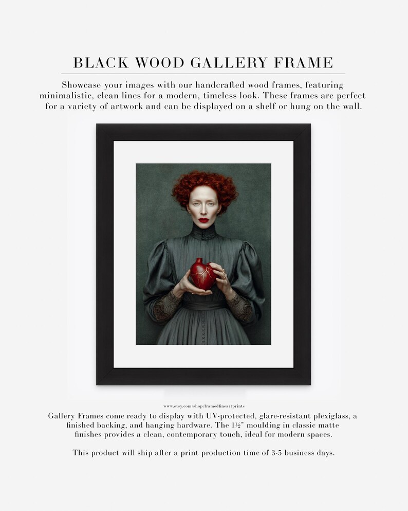 Fine art portrait of Cinder framed in black wood with white matte, ideal for bold modern interiors, featuring a woman with red curls holding a red anatomical heart vessel.