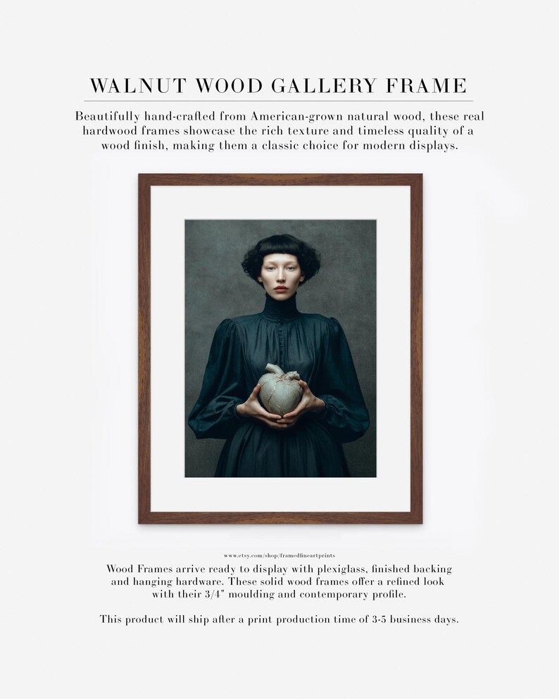 Sable framed in a walnut wood gallery frame with white matte, featuring a woman holding a kintsugi heart in a dark high-collar dress.