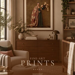Large framed Maren portrait displayed above a walnut dresser in a contemporary nursery with cream linen seating, warm neutral walls, plants, and soft natural textures.