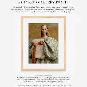 Sidonie portrait displayed in a natural ash wood gallery frame with wide white matting and a soft sage, cream, rust, and ochre palette.
