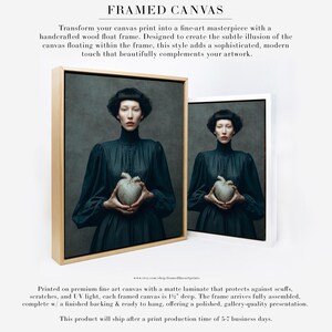 Framed canvas version of Sable, a woman in a dark dress holding a kintsugi heart, displayed in a handcrafted wood float frame for fine art presentation.