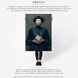 Unframed fine art print of Sable holding a gray ceramic heart, with archival quality and sharp detail, printed on professional-grade paper.