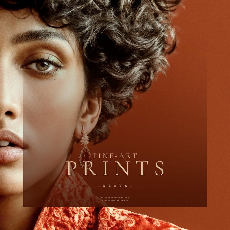 Close detail of Kavya fine art print showing eye, curls, earring, and rust textile against terracotta background
